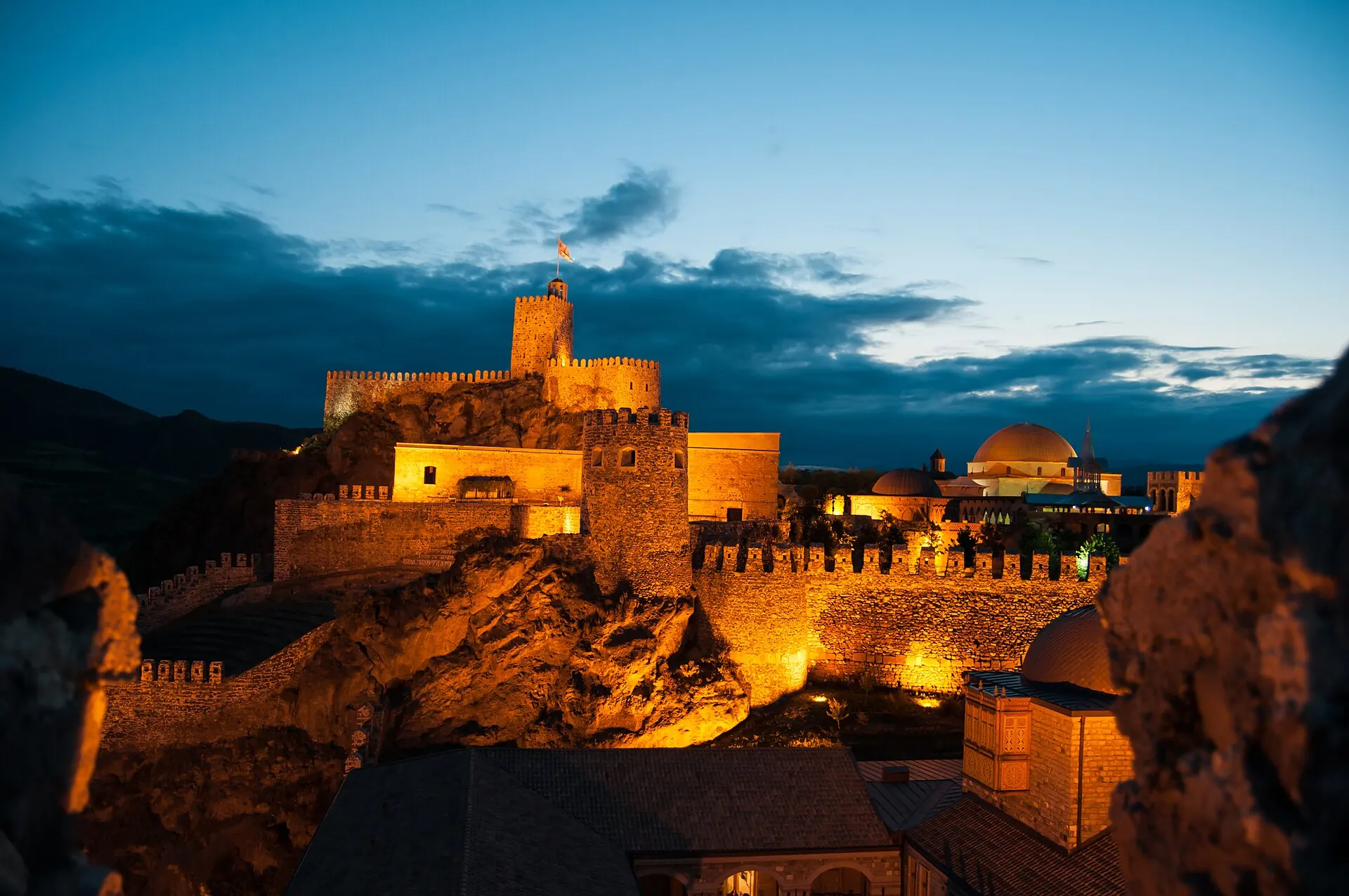 Illuminated stone towers and walls of Rabati Fortress above Akhaltsikhe at dusk