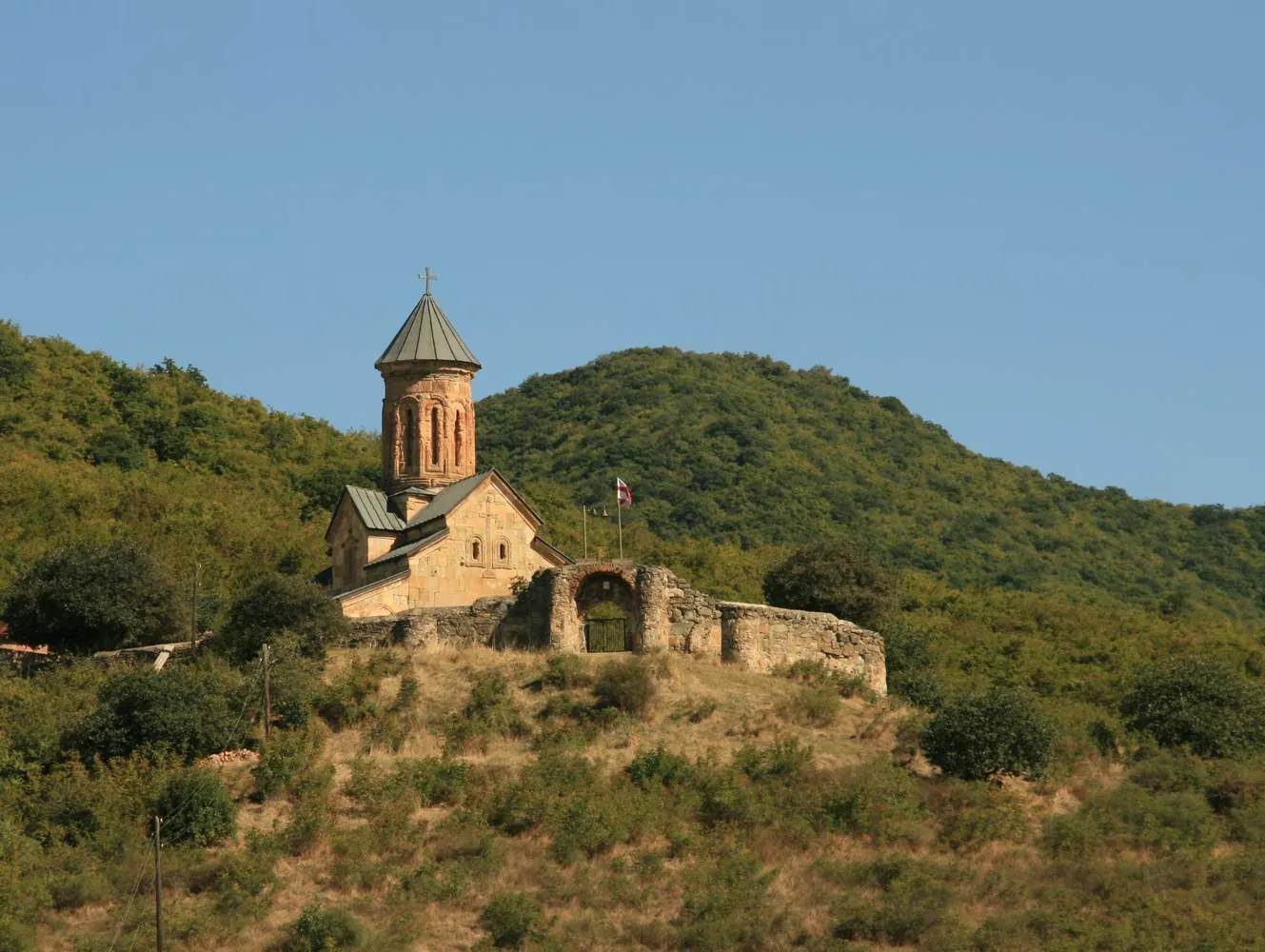 Tsughrughasheni Church on a green hillside near Bolnisi