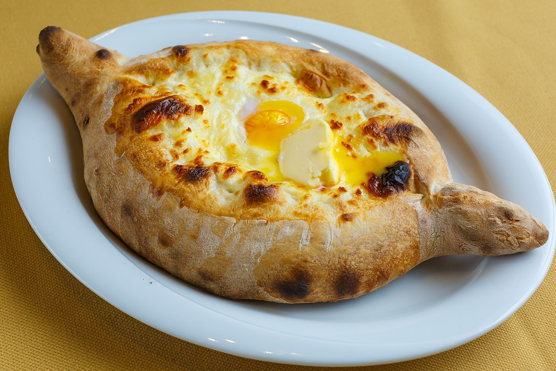 Boat-shaped Adjarian khachapuri filled with cheese, egg and butter