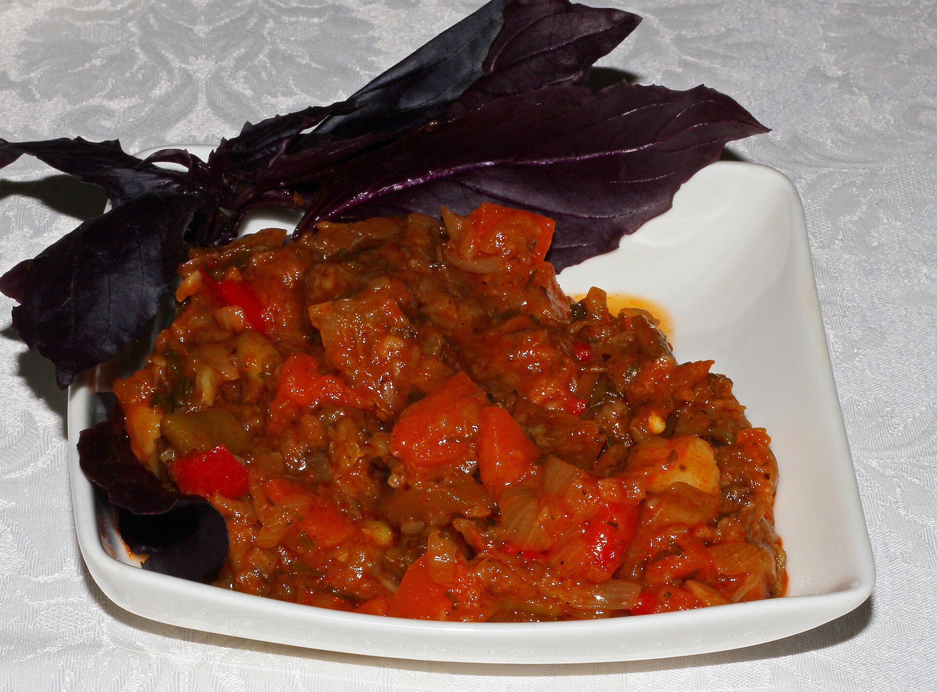 Ajapsandali with eggplant, peppers and tomatoes in a white bowl