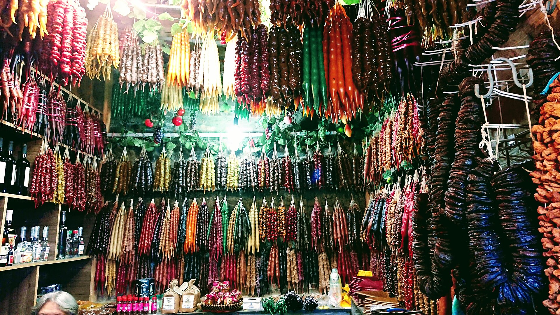Rows of colorful churchkhela hanging in a Georgian market stall
