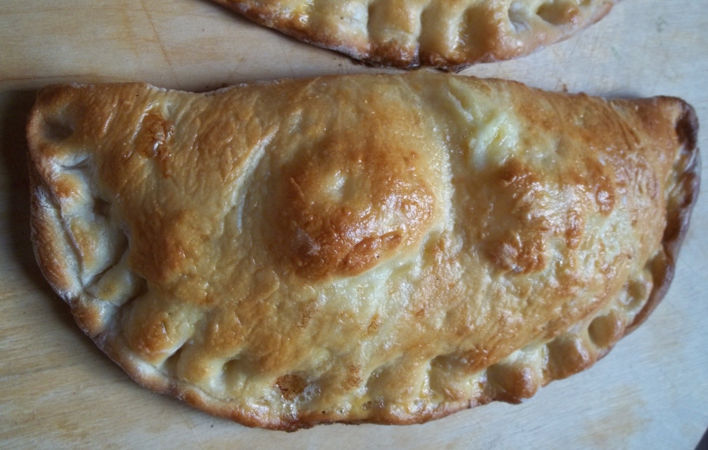 Golden crescent-shaped Gurian cheese and egg pastry