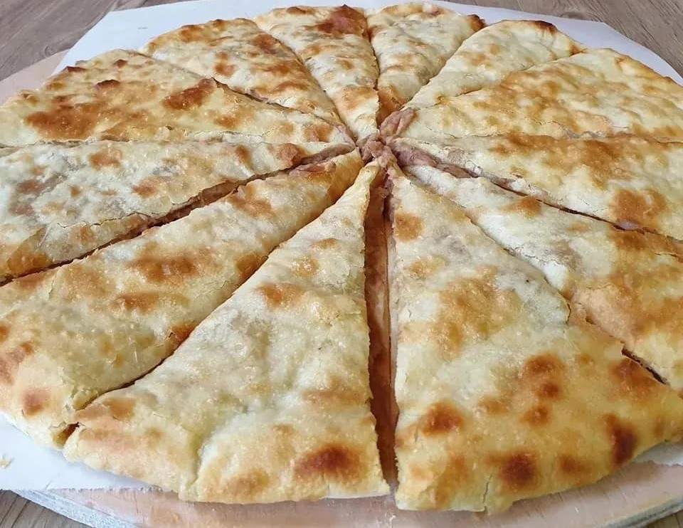 Round bean-filled lobiani cut into triangular slices