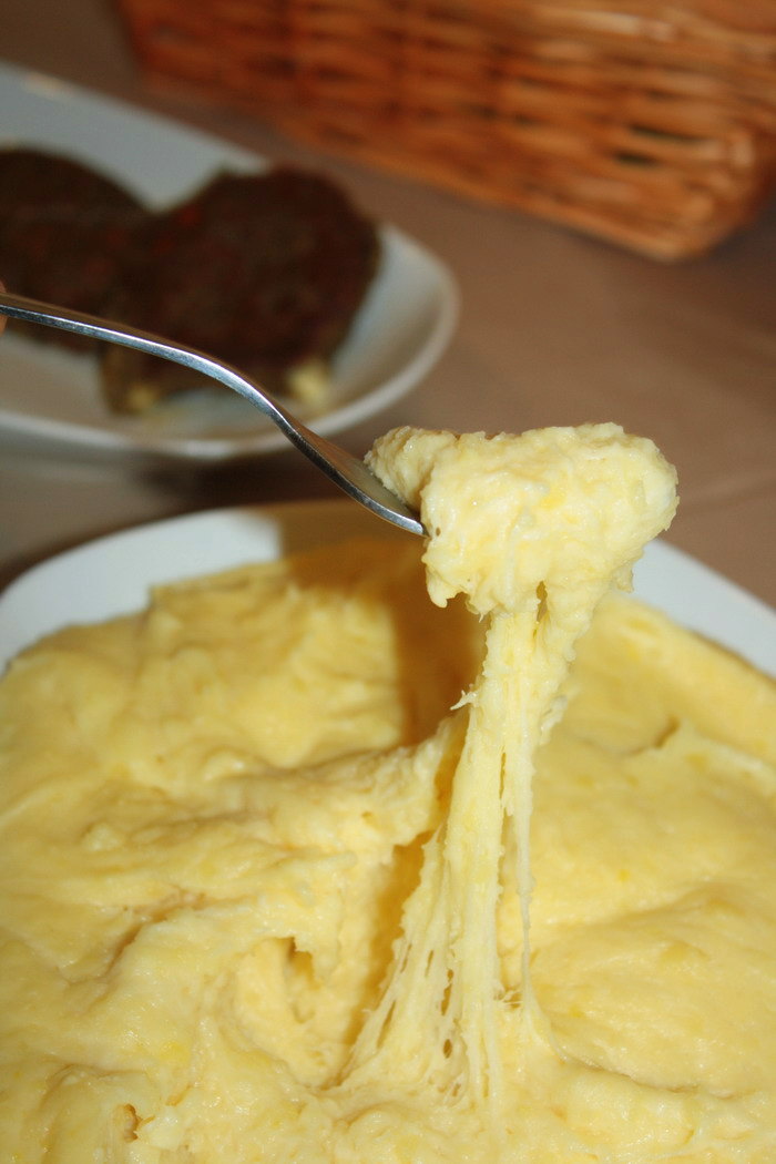 Stretchy cheese and mashed potatoes lifted with a fork