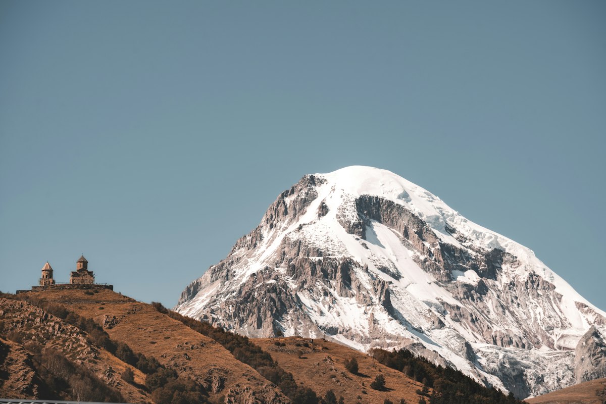 Gergeti Trinity Church beneath snow-capped mountains in Kazbegi