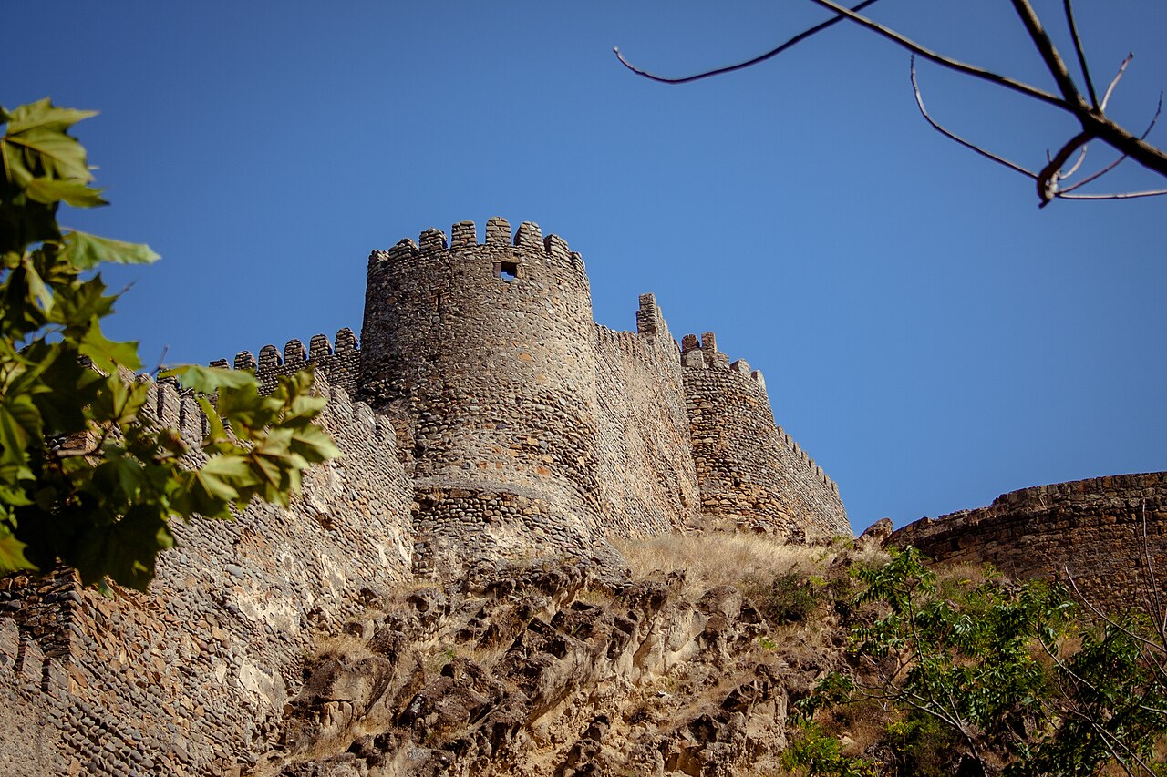 Stone walls and towers rising above Gori