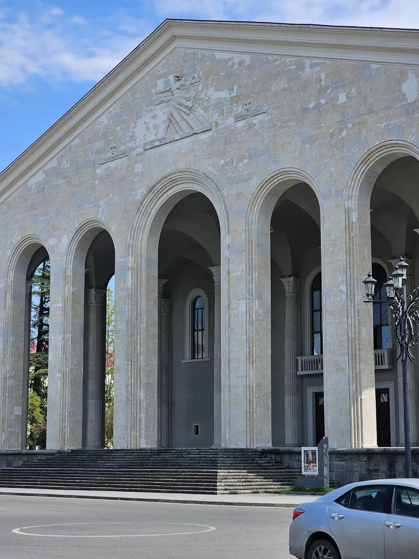 Pale stone arches on the facade of Ozurgeti Drama Theatre