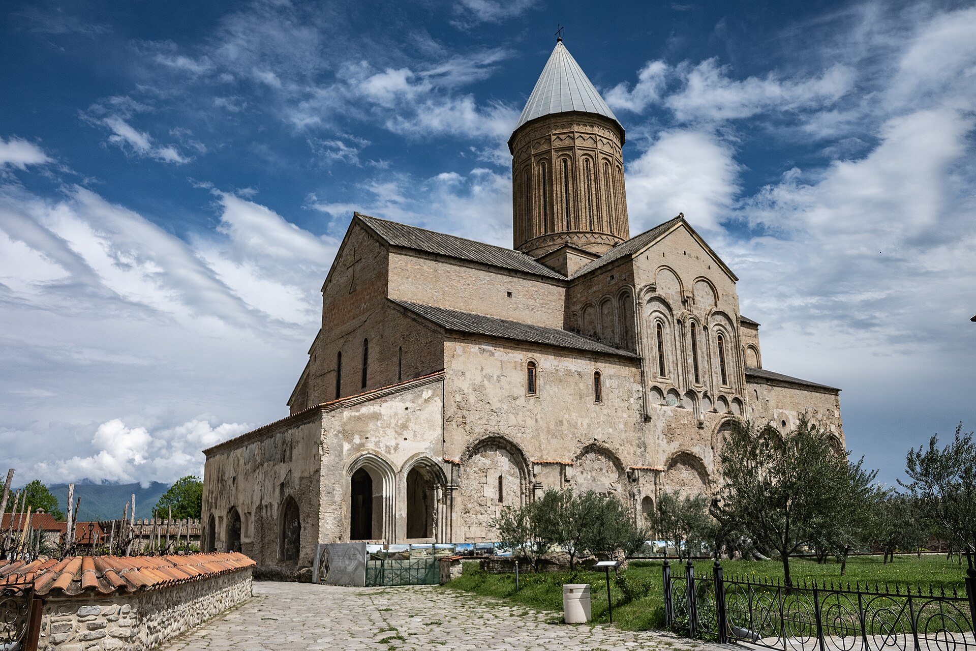 Tall stone cathedral at Alaverdi Monastery beneath a blue sky