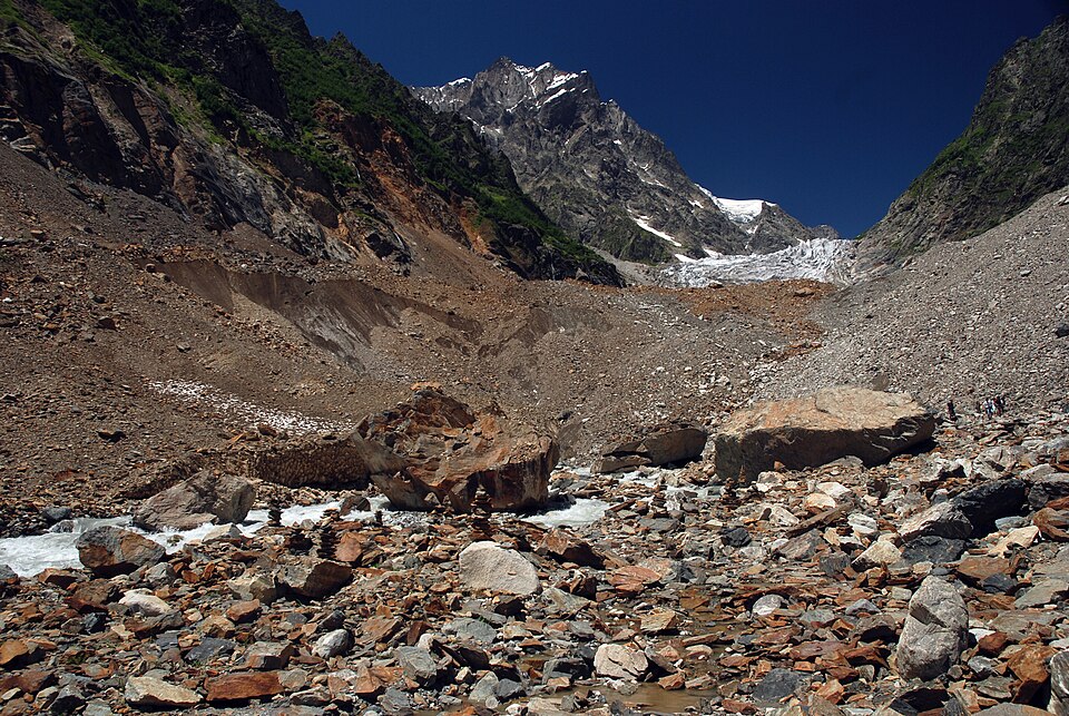 Rocky valley and distant Chalaadi Glacier beneath Mount Chatintau