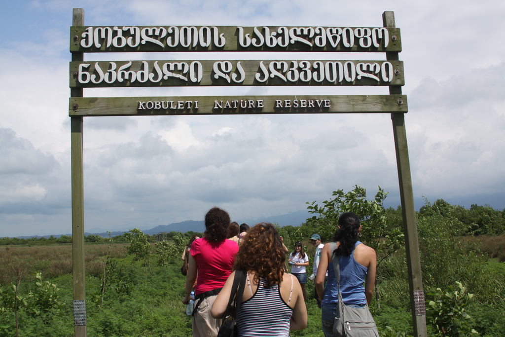 Visitors beneath the Kobuleti Nature Reserve sign at the wetland