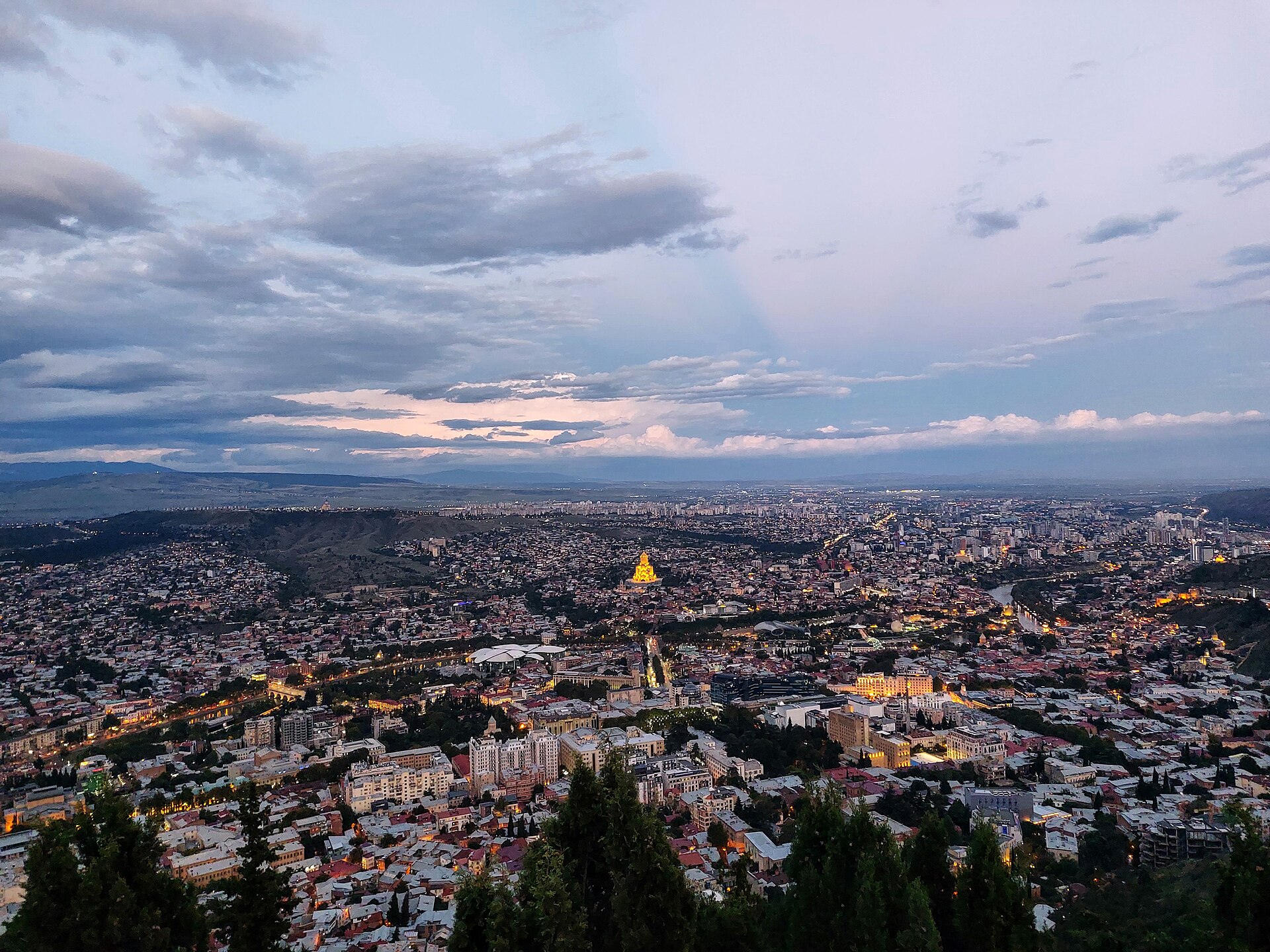 Wide evening view across central Tbilisi from Mtatsminda