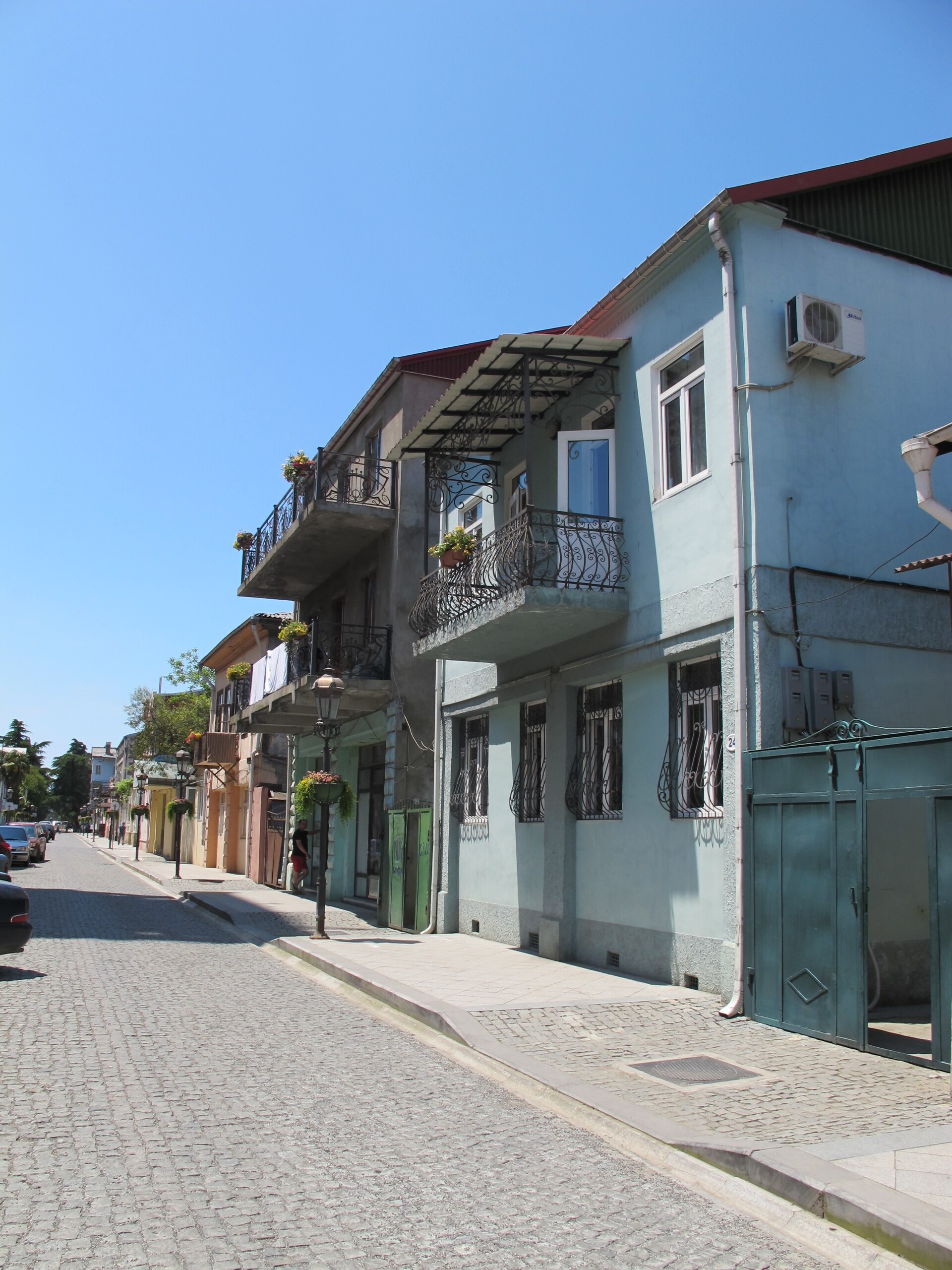Cobbled street with residential balconies in Old Batumi