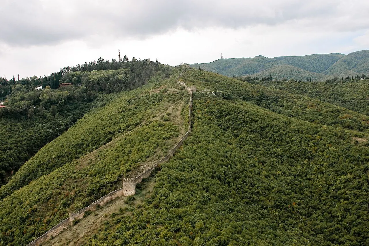 Fortress walls crossing a green ridge above Sighnaghi