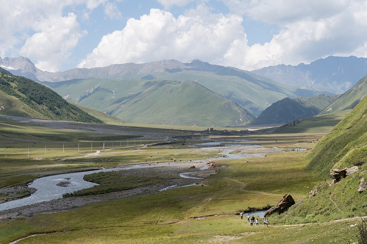River winding through the broad green Truso Valley